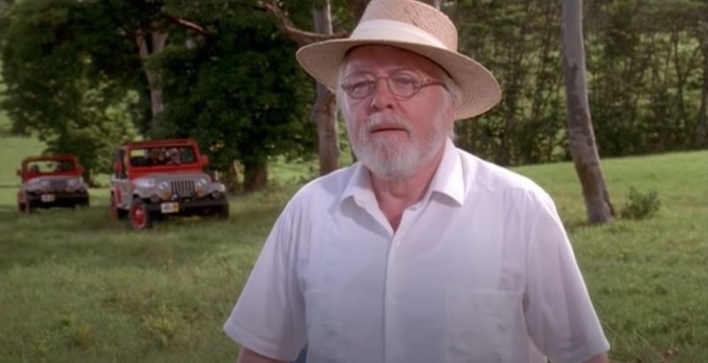 Image of John Hammond, from Jurassic Park, in the scene where he welcomes people to Jurassic Park.